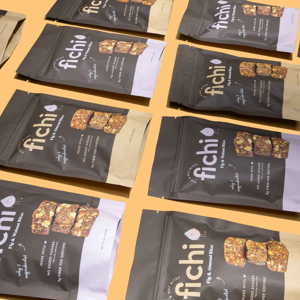 Fichi snack bite packages an orange background.