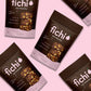 Fichi Fig and Walnut snack packages on a pink background.