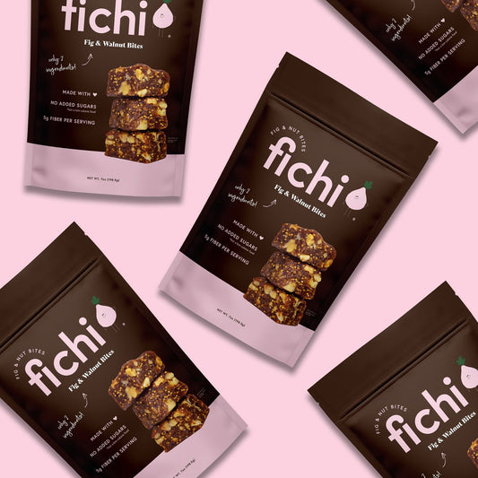 Fichi Fig and Walnut snack packages on a pink background.