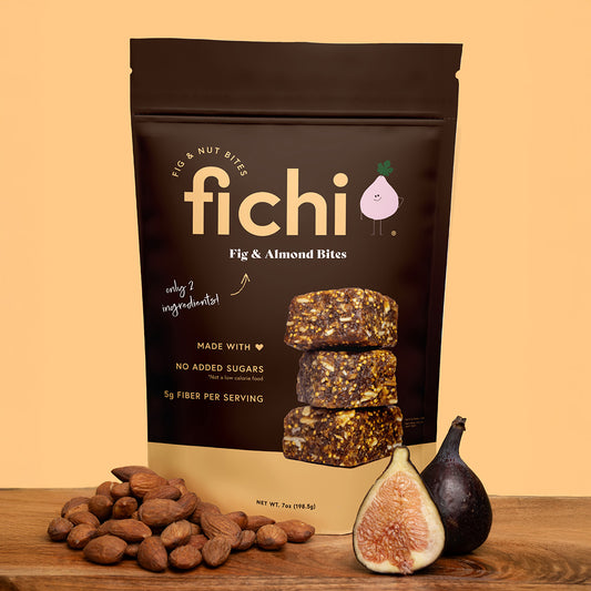 Fichi Fig & Almond Bites packaging with figs and almonds on a pink background.